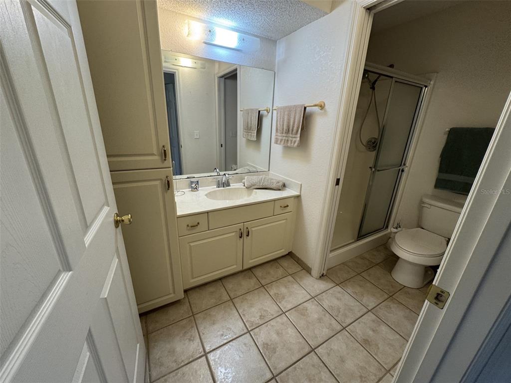329 Genesis Pointe Drive, Unit 329 Lake Wales, FL 33859 - Photo 22 of 29 a bathroom with a sink toilet and shower
