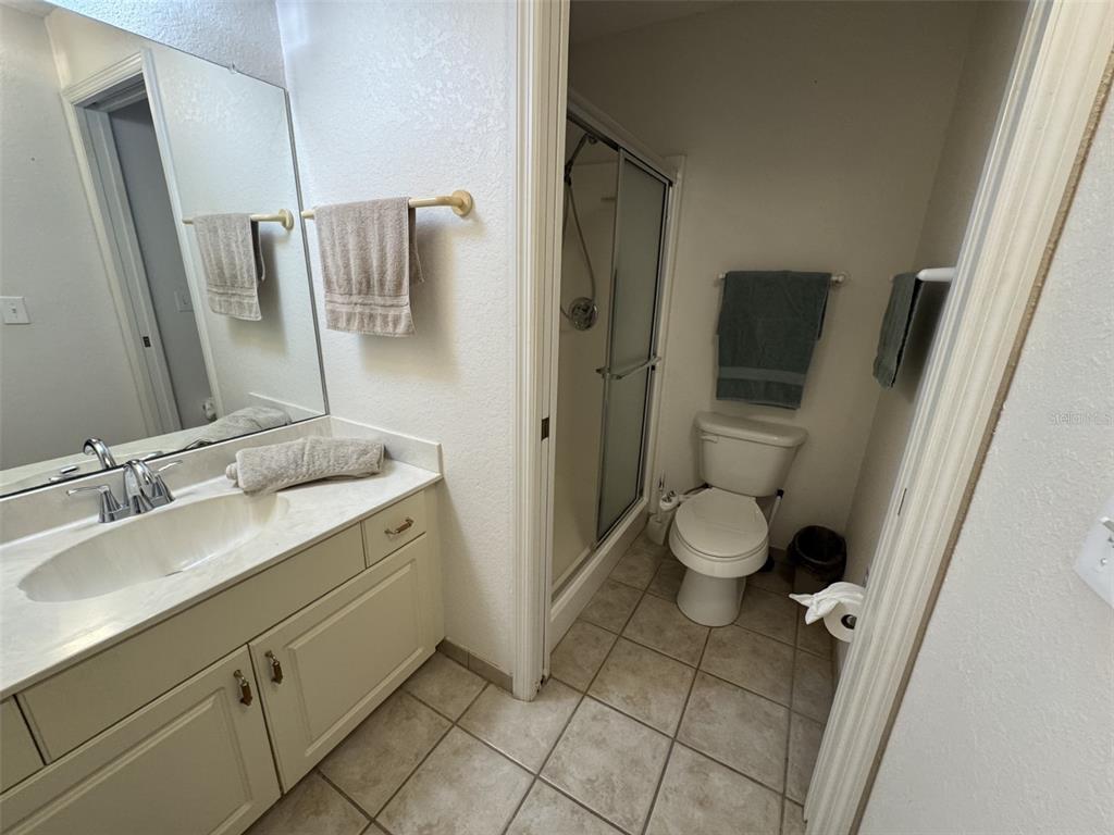 329 Genesis Pointe Drive, Unit 329 Lake Wales, FL 33859 - Photo 23 of 29 a bathroom with a granite countertop sink toilet and shower