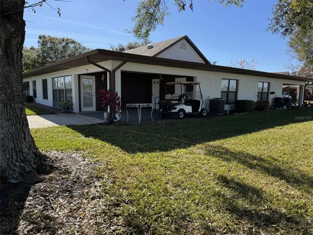 a view of a house with backyard porch and sitting area
