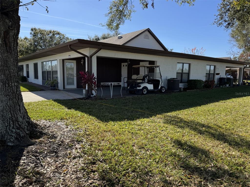 329 Genesis Pointe Drive, Unit 329 Lake Wales, FL 33859 - Photo 4 of 29 a view of a house with backyard porch and sitting area