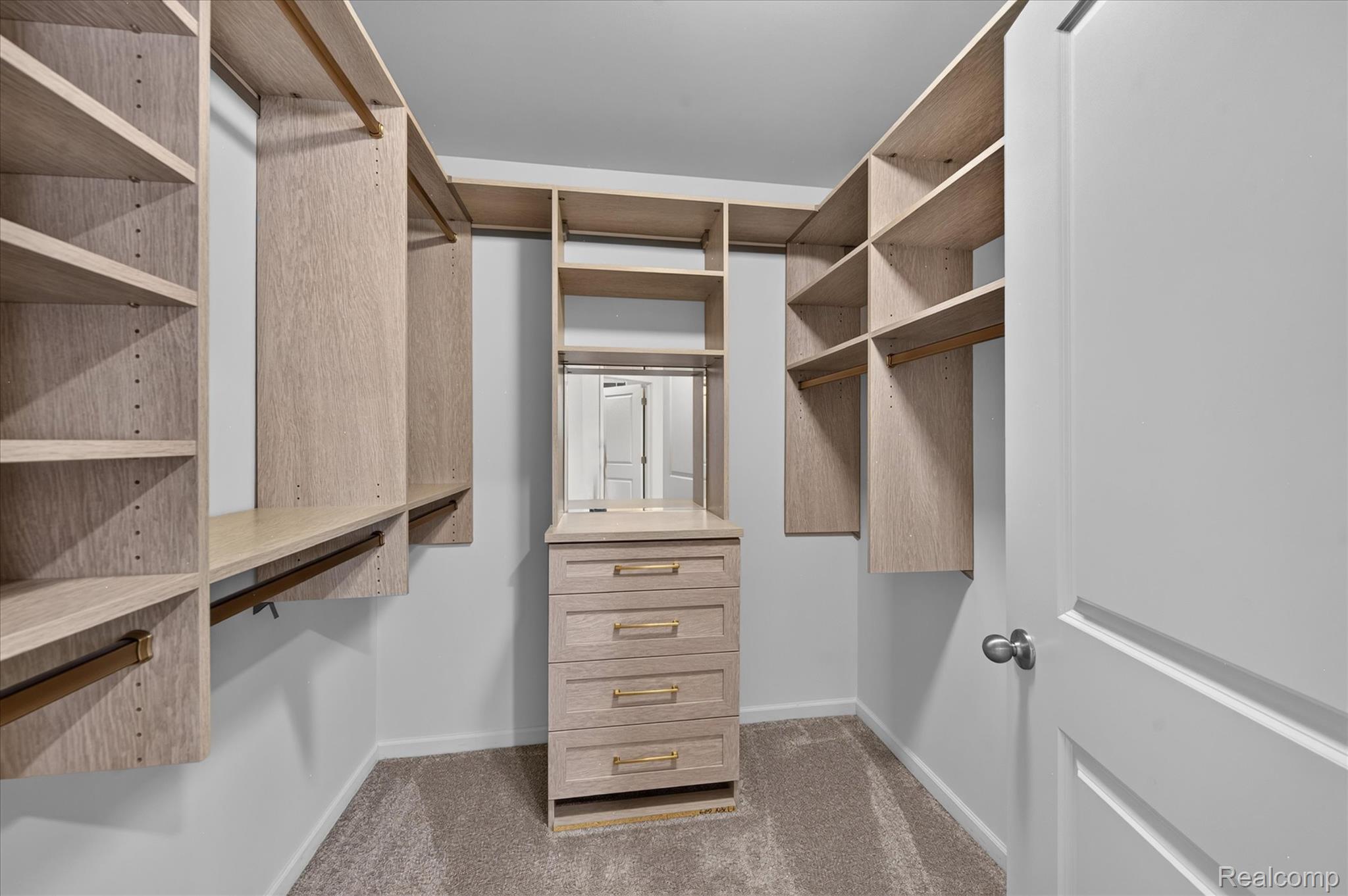 9911 Ridge Run Street Howell, MI 48855 - Photo 16 of 35 Custom California walk-in closet with extensive built-in storage.
