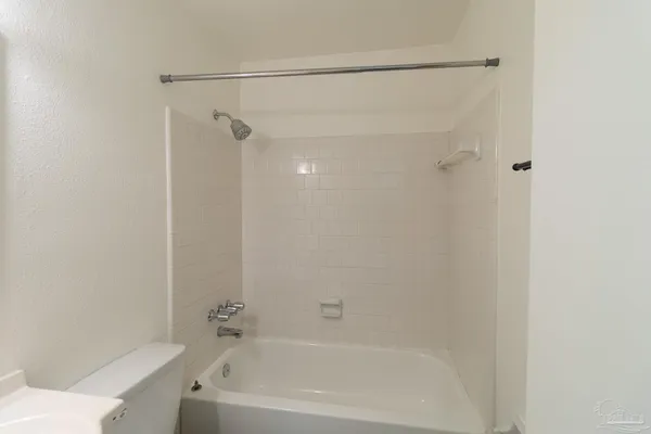 a bathroom with a shower and a bath tub