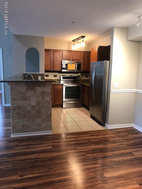 8550 Touchton Road, Unit 938 Jacksonville, FL 32216 - Photo 1 of 32 a kitchen with granite countertop a refrigerator and a stove