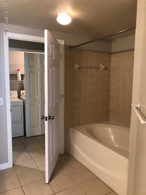 8550 Touchton Road, Unit 938 Jacksonville, FL 32216 - Photo 11 of 32 a bathroom with a bathtub and a shower