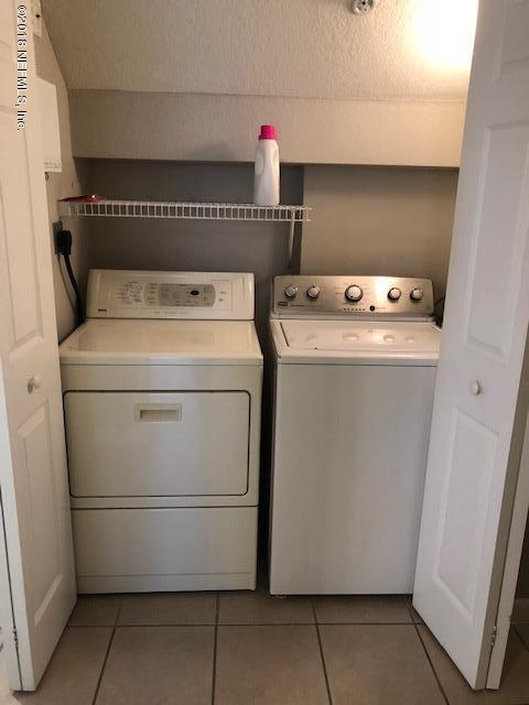 8550 Touchton Road, Unit 938 Jacksonville, FL 32216 - Photo 12 of 32 a utility room with dryer and washer