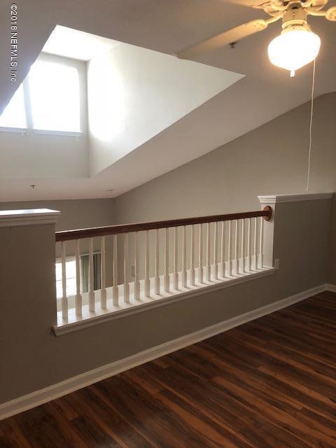 8550 Touchton Road, Unit 938 Jacksonville, FL 32216 - Photo 16 of 32 a view of an empty room with wooden floor and a window