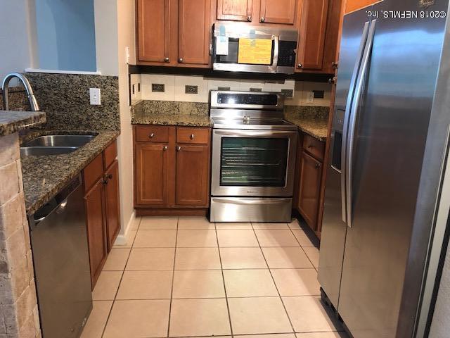 8550 Touchton Road, Unit 938 Jacksonville, FL 32216 - Photo 19 of 32 a kitchen with stainless steel appliances granite countertop a refrigerator and a stove
