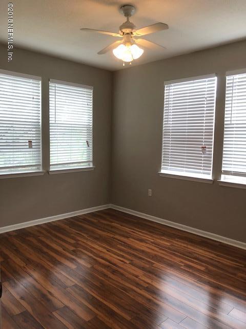 8550 Touchton Road, Unit 938 Jacksonville, FL 32216 - Photo 21 of 32 a view of an empty room with wooden floor and a window