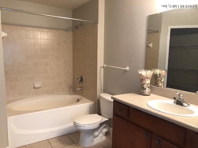 8550 Touchton Road, Unit 938 Jacksonville, FL 32216 - Photo 22 of 32 a bathroom with a bathtub shower sink vanity mirror and toilet