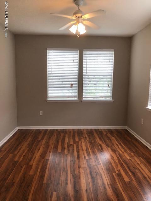 8550 Touchton Road, Unit 938 Jacksonville, FL 32216 - Photo 26 of 32 an empty room with wooden floor and windows