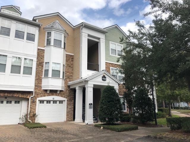 8550 Touchton Road, Unit 938 Jacksonville, FL 32216 - Photo 29 of 32 a view of a white building among the street with palm trees