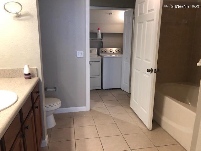 8550 Touchton Road, Unit 938 Jacksonville, FL 32216 - Photo 30 of 32 a bathroom with a sink a toilet and shower