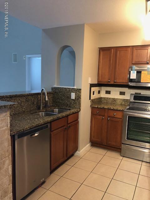 8550 Touchton Road, Unit 938 Jacksonville, FL 32216 - Photo 3 of 32 a kitchen with stainless steel appliances granite countertop a stove a sink and a microwave