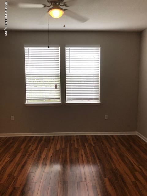 8550 Touchton Road, Unit 938 Jacksonville, FL 32216 - Photo 32 of 32 an empty room with wooden floor and windows