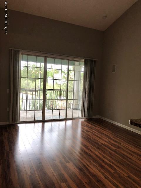 8550 Touchton Road, Unit 938 Jacksonville, FL 32216 - Photo 5 of 32 a view of an empty room with wooden floor and a window