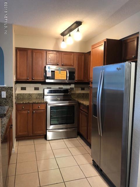 8550 Touchton Road, Unit 938 Jacksonville, FL 32216 - Photo 6 of 32 a kitchen with stainless steel appliances and a refrigerator