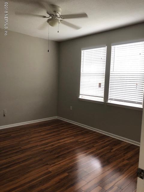 8550 Touchton Road, Unit 938 Jacksonville, FL 32216 - Photo 8 of 32 an empty room with wooden floor and windows