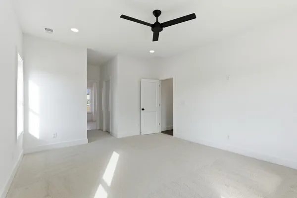 a view of a livingroom with a ceiling fan and window