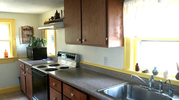 73 Wellesley Road Natick, MA 01760 - Photo 4 of 11 a kitchen with a sink cabinets and window