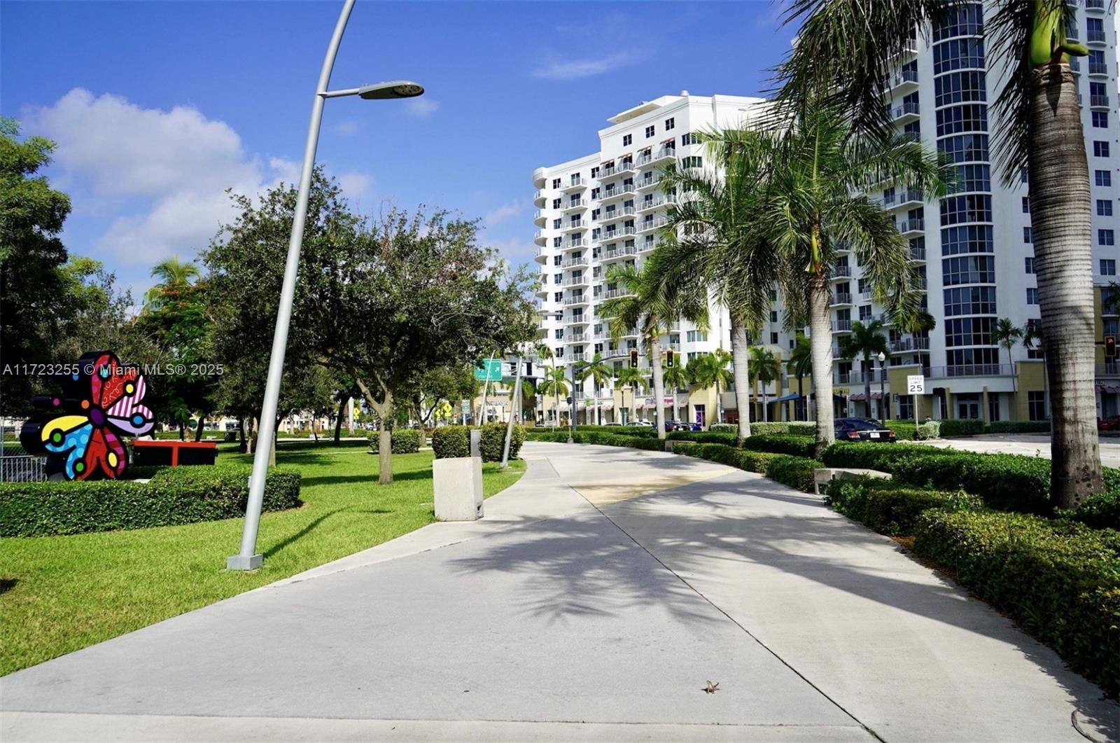 1830 Radius Drive, Unit 810 Hollywood, FL 33020 - Photo 17 of 26 a view of a house with a yard and potted plants