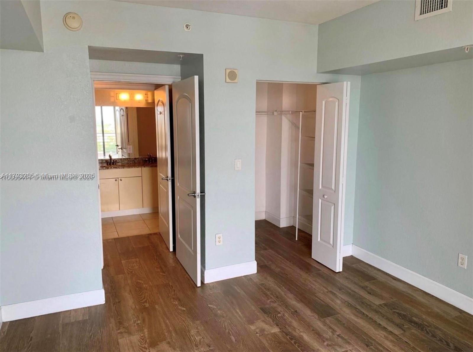 1830 Radius Drive, Unit 810 Hollywood, FL 33020 - Photo 24 of 26 an empty room with wooden floor and a window