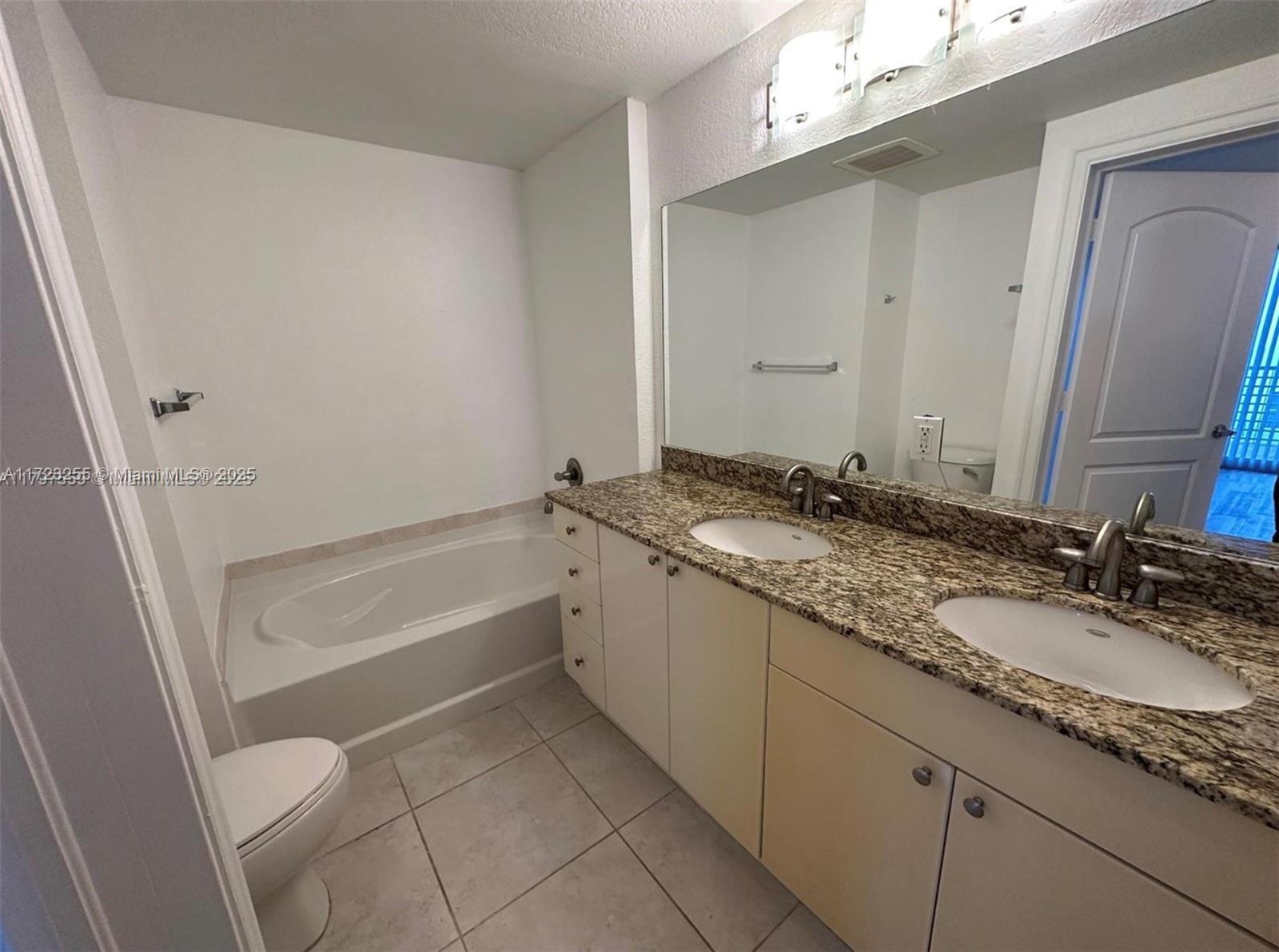 1830 Radius Drive, Unit 810 Hollywood, FL 33020 - Photo 25 of 26 a bathroom with a granite countertop sink and a mirror