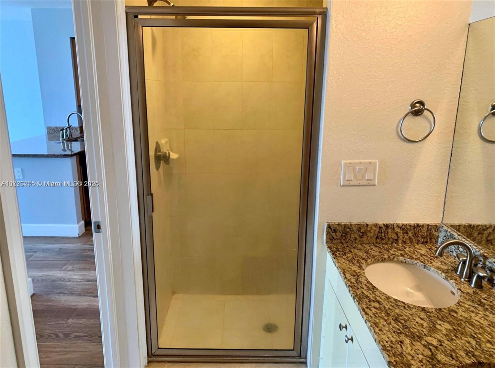 1830 Radius Drive, Unit 810 Hollywood, FL 33020 - Photo 26 of 26 a bathroom with a granite countertop sink and a mirror