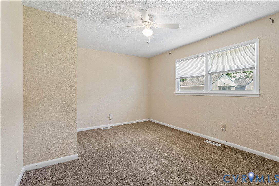 6 Barnes Court Hampton, VA 23664 - Photo 16 of 38 an empty room with wooden floor and windows