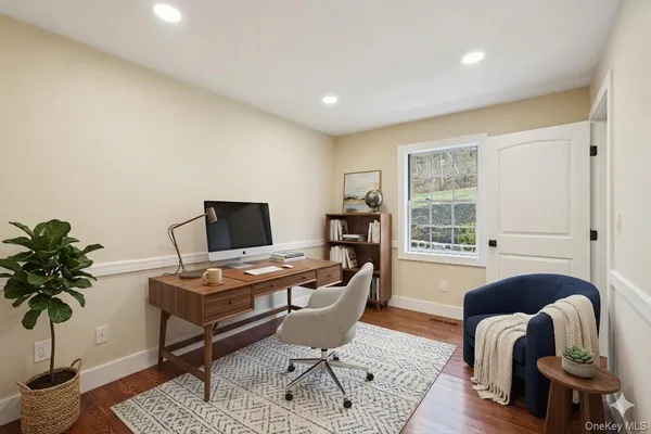 a living room with furniture and a potted plant