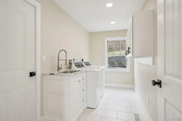 a bathroom with a sink mirror and a bathtub