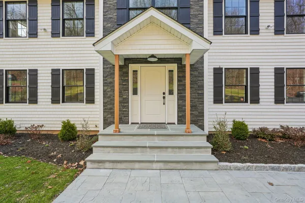 a front view of a house with potted plants