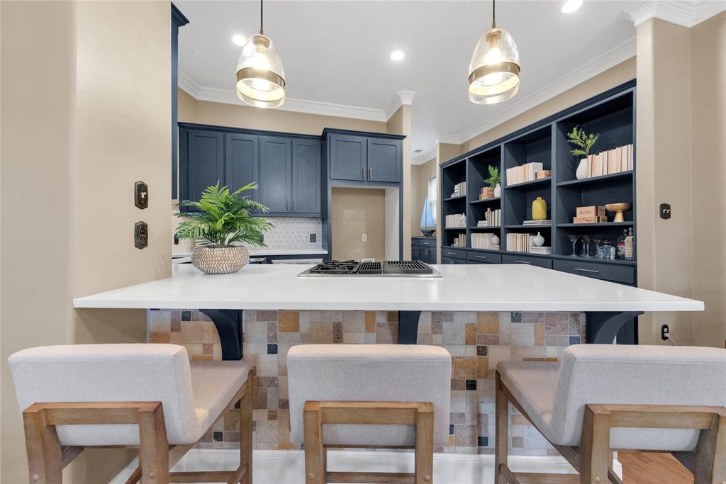 5102 Ridgedale Avenue Dallas, TX 75206 - Photo 11 of 27 Kitchen island with a white countertop and integrated cooktop