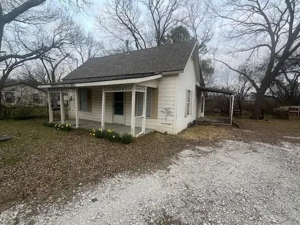 a view of a house with a yard and garage