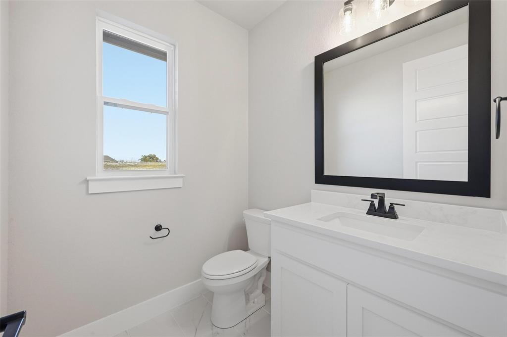 108 Rocky Top Azle, TX 76020 - Photo 24 of 40 a bathroom with a toilet sink and mirror