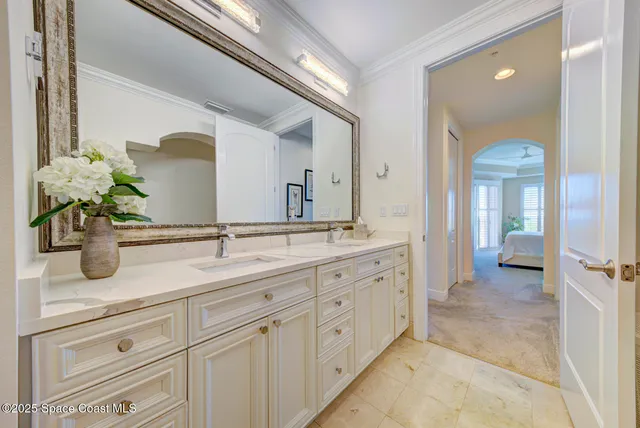a bathroom with a double vanity sink toilet mirror and bathtub