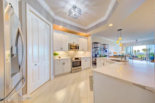 a kitchen with stainless steel appliances a refrigerator and a cabinets