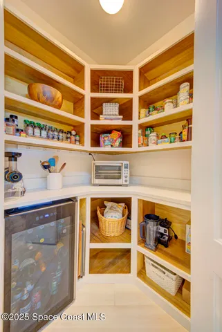a large white kitchen with a large window