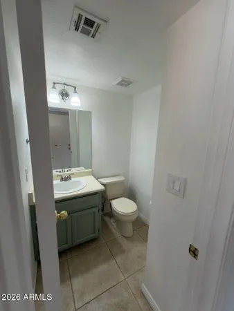 a bathroom with a sink and mirror with toilet