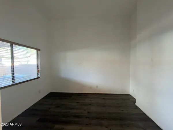 a view of wooden floor and windows in a room