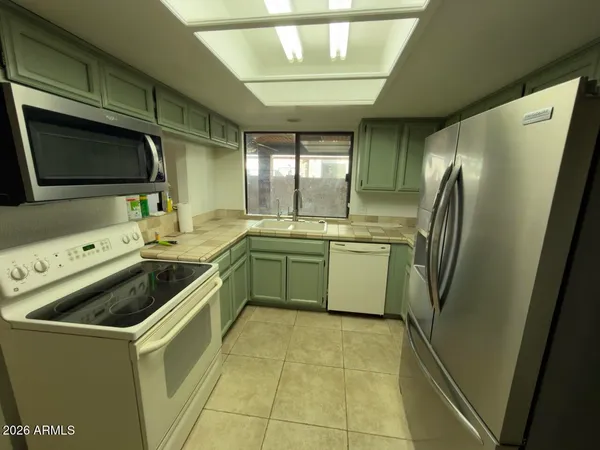 a kitchen with a sink stove and refrigerator