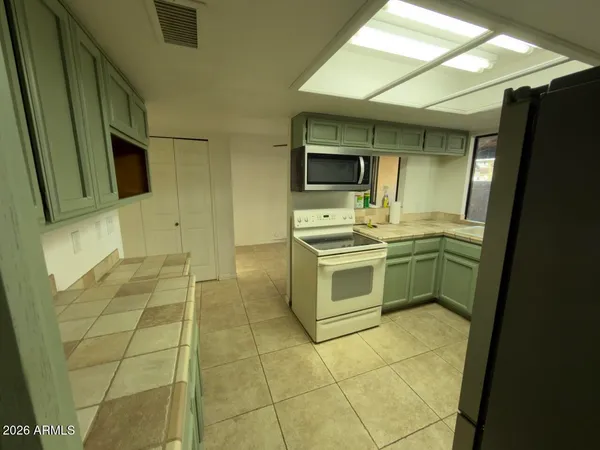 a kitchen with stainless steel appliances a stove a sink and a microwave
