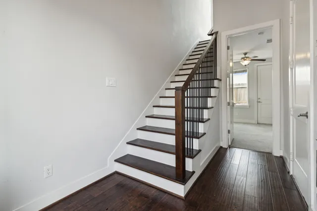 a view of a hallway with wooden floor and entryway