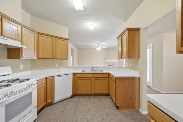 a kitchen with a sink stove and cabinets