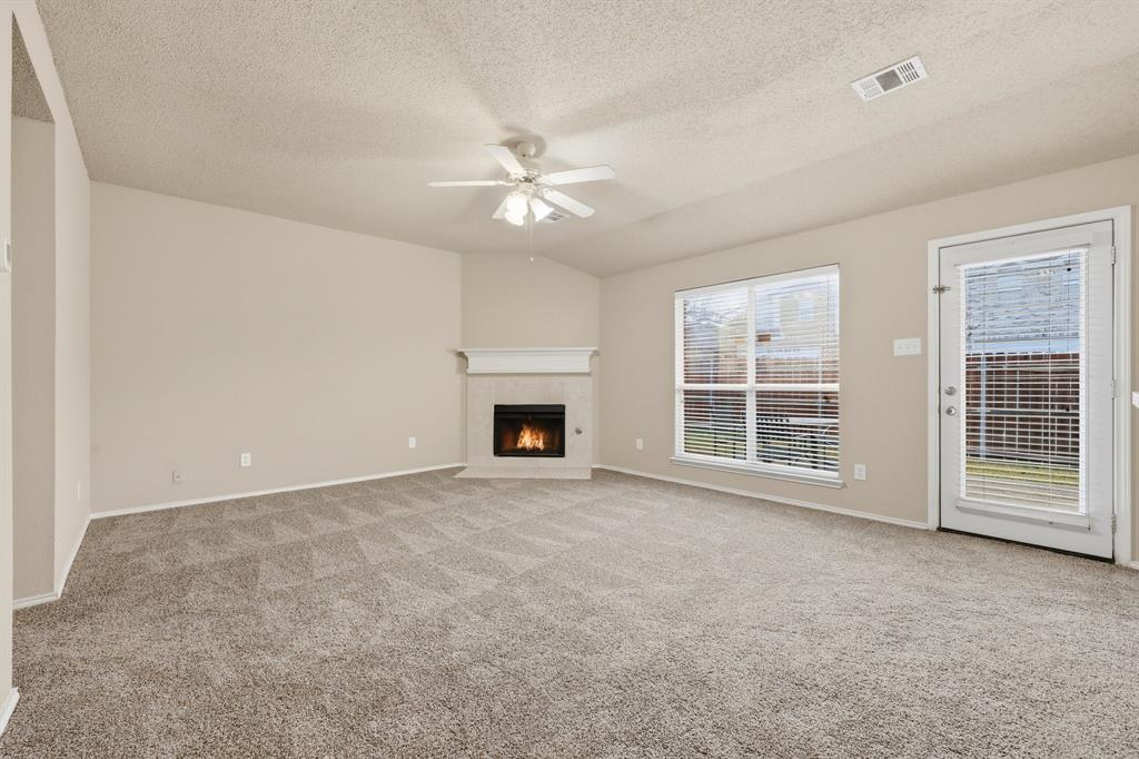 1410 Deville Circle Garland, TX 75043 - Photo 5 of 11 an empty room with windows and ceiling fan