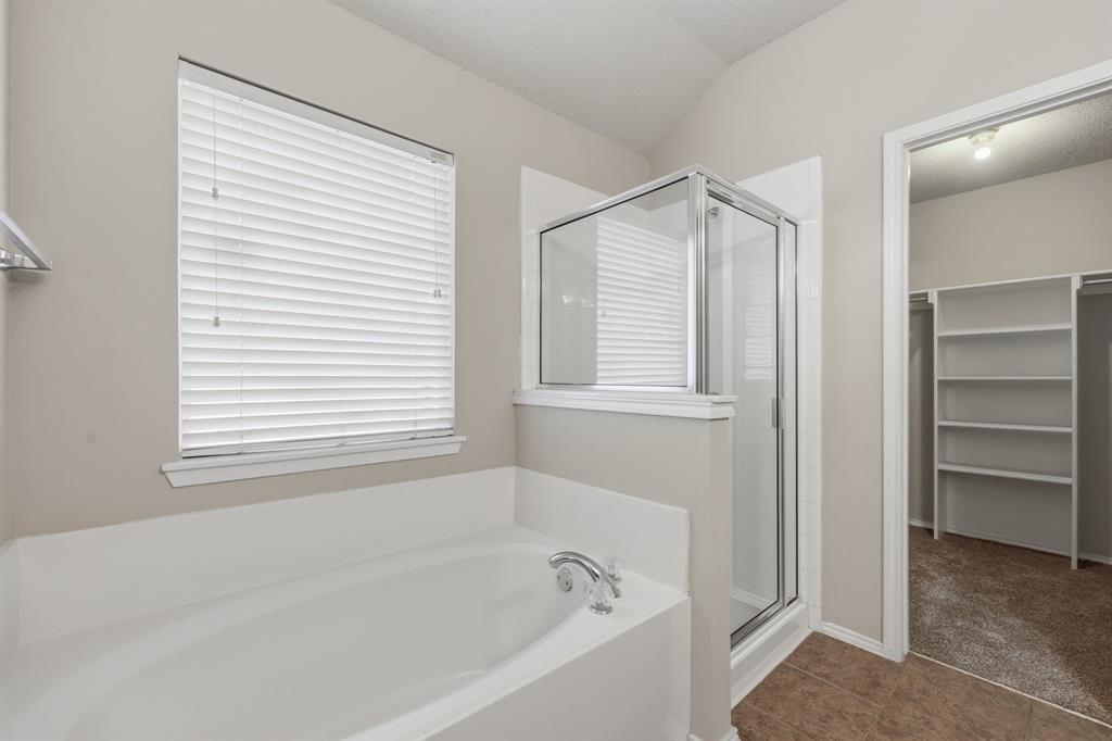 1410 Deville Circle Garland, TX 75043 - Photo 7 of 11 a white bath tub sitting next to a window