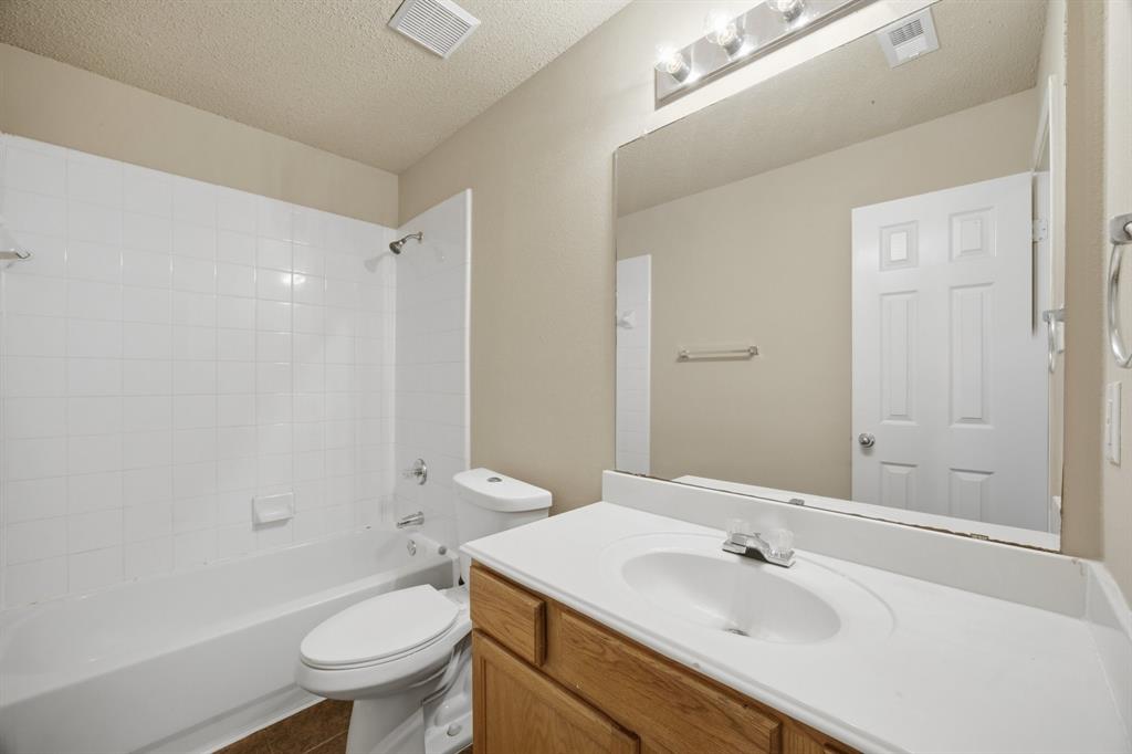 1410 Deville Circle Garland, TX 75043 - Photo 9 of 11 a bathroom with a sink toilet tub and shower