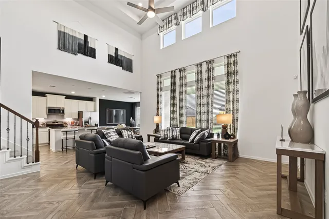 a living room with furniture or couch and a ceiling fan