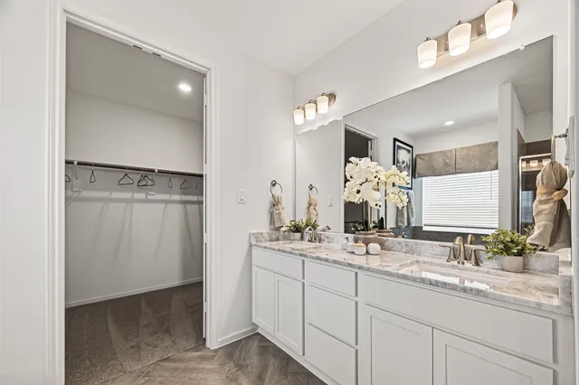 a bathroom with a tub a sink and a shower