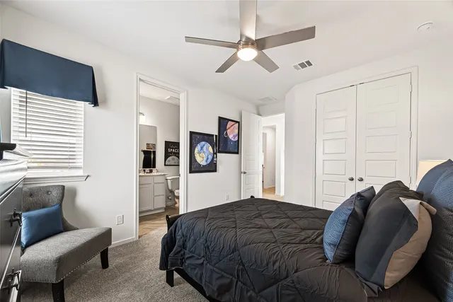 a bedroom with a bed and a dresser