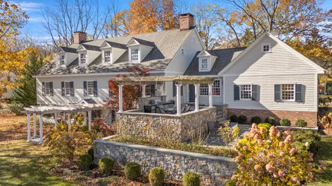 a front view of a house with yard and trees